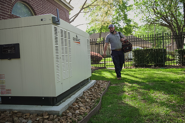 Generac generator installation specialist walking around the house to the Generac generator